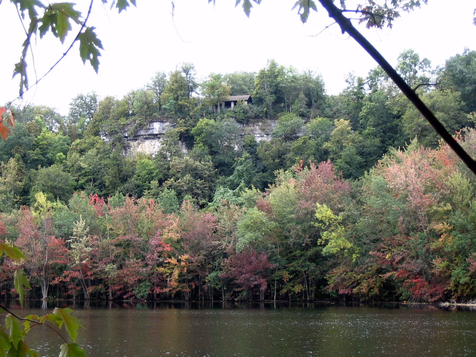 Limestone cliff above the lake at Clark Reservation State Park in early fall color