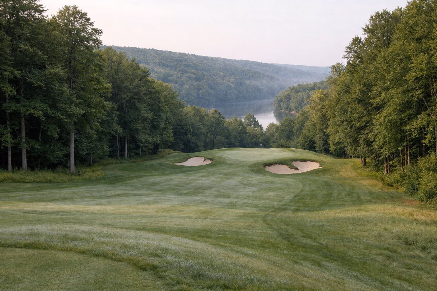 Rolling tree-lined fairway sloping to a green with deep bunkers